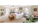Bright bedroom featuring neutral walls, two windows, and a comfortable sitting area with green chairs at 2229 S Van Wert S Rd, Villa Rica, GA 30180