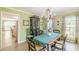 Inviting dining room features a stylish chandelier, hardwood floors, and plenty of natural light at 2229 S Van Wert S Rd, Villa Rica, GA 30180