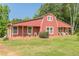 Inviting barn home with a covered porch and manicured lawn, perfect for relaxing and enjoying the outdoors at 2229 S Van Wert S Rd, Villa Rica, GA 30180