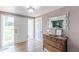 Bright foyer features light-colored walls, hardwood floors, antique cabinet, and decorative mirror and light fixture at 2229 S Van Wert S Rd, Villa Rica, GA 30180