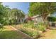 Tranquil garden area with raised beds, lush greenery, and a charming backdrop, perfect for gardening enthusiasts at 2229 S Van Wert S Rd, Villa Rica, GA 30180