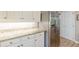 Well-lit kitchen featuring white cabinets, stainless steel refrigerator, granite countertops and hardwood floors at 2229 S Van Wert S Rd, Villa Rica, GA 30180