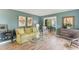 Serene living room featuring hardwood floors, complemented by blue walls, charming furnishings, and abundant natural light at 2229 S Van Wert S Rd, Villa Rica, GA 30180