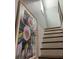 A staircase with wooden steps and white risers, complemented by a framed floral painting at 2229 S Van Wert S Rd, Villa Rica, GA 30180