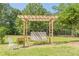 Relaxing backyard swing under a wooden pergola, perfect for enjoying the outdoors at 2229 S Van Wert S Rd, Villa Rica, GA 30180