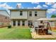 A well-maintained backyard featuring a patio dining area and manicured lawn and fence at 2837 Peachstone Ct, Lawrenceville, GA 30043