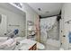 Bathroom with shower and bathtub, complemented by stylish storage and decor at 2837 Peachstone Ct, Lawrenceville, GA 30043