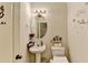 This cozy bathroom has a white sink and decorative wallpaper at 2837 Peachstone Ct, Lawrenceville, GA 30043