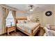 Bedroom with wood-style floors, a ceiling fan and a bed with pillows at 2837 Peachstone Ct, Lawrenceville, GA 30043