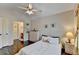Vaulted ceiling bedroom with warm light, dresser, and a glimpse into the bathroom at 2837 Peachstone Ct, Lawrenceville, GA 30043