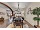 A dining room with dark hardwood floors, modern light fixture, and beautiful archways at 2837 Peachstone Ct, Lawrenceville, GA 30043