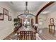 An elegant dining room featuring dark hardwood floors and trim and a modern light fixture at 2837 Peachstone Ct, Lawrenceville, GA 30043