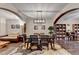 Dining room featuring dark hardwood floors, modern lighting, and a view of other living spaces at 2837 Peachstone Ct, Lawrenceville, GA 30043