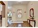 Elegant entryway with hardwood floors, detailed trim, and a decorative table with a mirror at 2837 Peachstone Ct, Lawrenceville, GA 30043