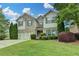 Charming two-story home features a well-manicured lawn, lush landscaping, and a welcoming two-car garage at 2837 Peachstone Ct, Lawrenceville, GA 30043