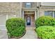 Inviting front entrance features a black door flanked by manicured shrubs and a walkway at 2837 Peachstone Ct, Lawrenceville, GA 30043