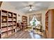 Inviting home office boasts custom bookshelves, wood floors, a ceiling fan, and ample natural light at 2837 Peachstone Ct, Lawrenceville, GA 30043