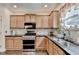 This bright kitchen has a stainless steel stove and granite countertops at 2837 Peachstone Ct, Lawrenceville, GA 30043