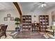 Spacious living room featuring built-in shelving, dark wood floors, and a modern ceiling fan at 2837 Peachstone Ct, Lawrenceville, GA 30043