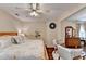 Spacious main bedroom boasts wood-style floors, a ceiling fan, decor and a vanity at 2837 Peachstone Ct, Lawrenceville, GA 30043