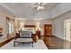 Bright main bedroom with a tray ceiling and polished hardwood floors at 2837 Peachstone Ct, Lawrenceville, GA 30043