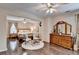 Inviting main bedroom with hardwood floors, seating area, and dresser with mirror at 2837 Peachstone Ct, Lawrenceville, GA 30043