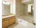 Bathroom with wooden cabinet, stone countertop, and walk-in bathtub at 2928 Riverset Ct, Decatur, GA 30034
