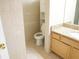 Bathroom with stone countertop, wooden cabinets, and white tiled walls at 2928 Riverset Ct, Decatur, GA 30034