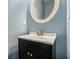 Powder room featuring an oval mirror, vanity with chrome hardware and light blue walls at 2928 Riverset Ct, Decatur, GA 30034