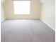 Bright bedroom with neutral carpeting and a large window providing natural light at 2928 Riverset Ct, Decatur, GA 30034