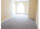 Bright bedroom featuring neutral carpet, large window, and a walk-in closet at 2928 Riverset Ct, Decatur, GA 30034