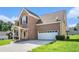 Brick-exterior two-story home with attached garage and well-maintained lawn at 2928 Riverset Ct, Decatur, GA 30034