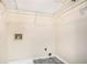 Laundry room with upper shelf, gray tile floor and utility hookups at 2928 Riverset Ct, Decatur, GA 30034