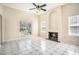 Sunlit living room featuring a corner fireplace, neutral walls, large windows and tile flooring at 2928 Riverset Ct, Decatur, GA 30034