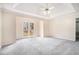 Main bedroom with large closet, ceiling fan, plush carpet, and access to outdoor deck at 2928 Riverset Ct, Decatur, GA 30034