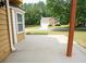 View of a concrete patio looking toward a detached garage in a large yard at 2928 Riverset Ct, Decatur, GA 30034