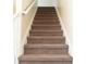 Carpeted staircase featuring neutral colors and white railings at 2928 Riverset Ct, Decatur, GA 30034