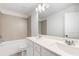 Well-lit bathroom showcasing double sinks with modern fixtures and a tiled shower-tub combo at 3546 Sorrel Ln, Duluth, GA 30096