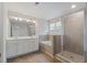 Spa-like bathroom boasts double sinks, bathtub, and a glass-enclosed shower at 3546 Sorrel Ln, Duluth, GA 30096