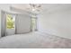 Expansive bedroom features neutral carpet and dual windows overlooking trees at 3546 Sorrel Ln, Duluth, GA 30096