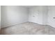 Spacious bedroom featuring plush carpeting, neutral paint, and two closet doors for storage at 3546 Sorrel Ln, Duluth, GA 30096