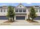Charming townhome with a modern exterior, featuring a two-car garage and well-manicured front yard at 3546 Sorrel Ln, Duluth, GA 30096