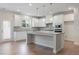 Bright kitchen with white cabinets, granite countertops, and a center island with pendant lighting at 3546 Sorrel Ln, Duluth, GA 30096
