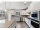 Beautiful kitchen featuring stainless appliances, gray countertops, and ample cabinet space at 3546 Sorrel Ln, Duluth, GA 30096