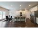 Spacious kitchen with island seating, stainless steel appliances, and a view into the dining area at 3557 Bryant Meadows Cir, Buford, GA 30519