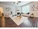 Living room area featuring a fireplace, stylish decor, ceiling fan and bright light from a window at 3557 Bryant Meadows Cir, Buford, GA 30519