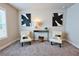 Bright sitting area with two upholstered chairs, stylish console table and eye-catching black and white decor at 3557 Bryant Meadows Cir, Buford, GA 30519
