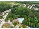 Aerial view of community pool and recreational area, surrounded by trees and homes at 7628 Summer Berry Ln, Lithonia, GA 30038