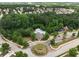 Aerial view of community pool, playground, and meticulously landscaped entrance at 7628 Summer Berry Ln, Lithonia, GA 30038