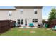 An open backyard with a small patio, seating, and a grill at 7628 Summer Berry Ln, Lithonia, GA 30038